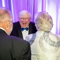 Enrichment Awardee Don Lubbers smiling at guests after the Enrichment Program
